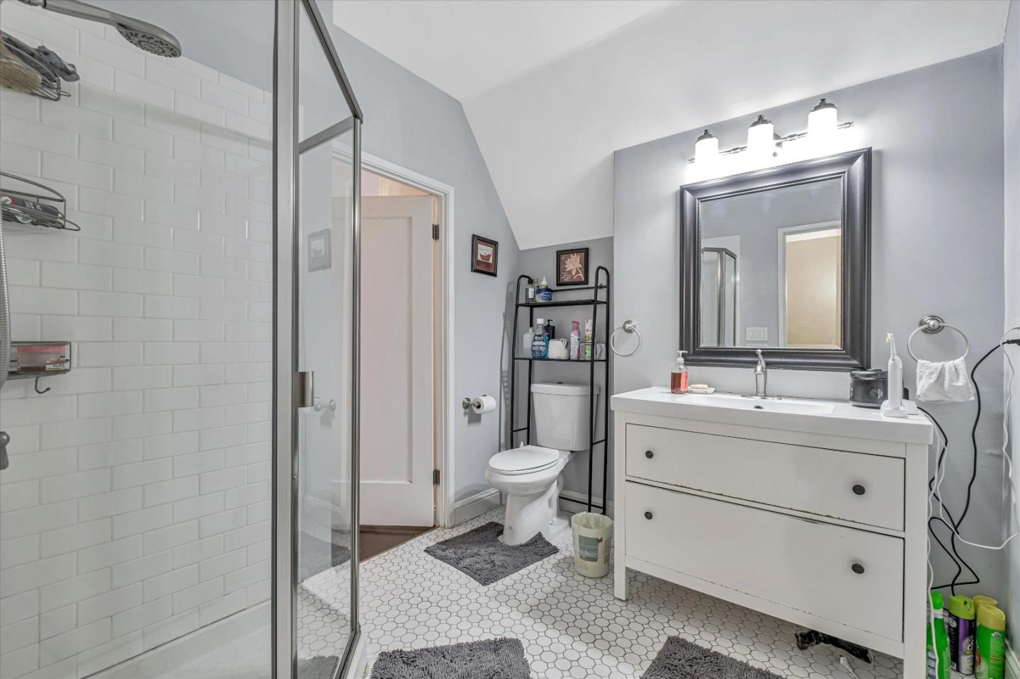 8245 Golf Links Road Oakland, CA 94605 - Photo 32 of 41 a bathroom with a toilet sink and mirror