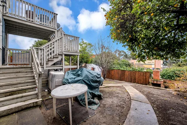a view of a chairs and table in backyard