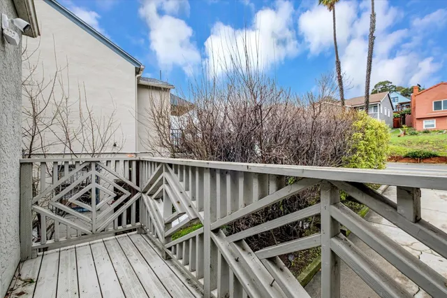a view of balcony with wooden floor and fence