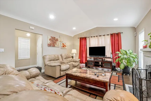 a living room with furniture flat screen tv and a fireplace