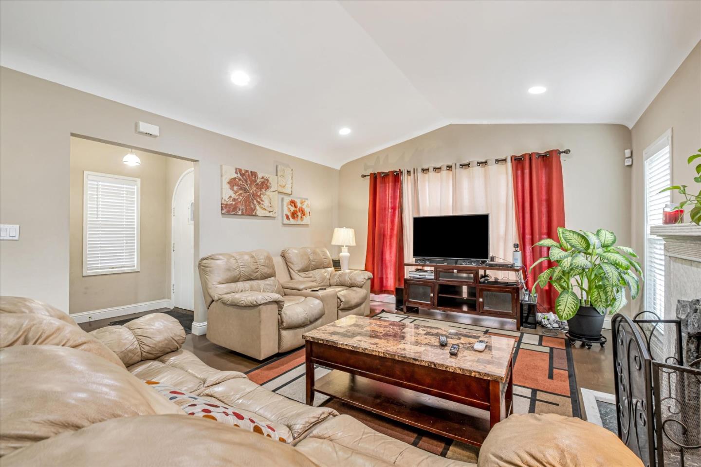 8245 Golf Links Road Oakland, CA 94605 - Photo 7 of 41 a living room with furniture flat screen tv and a fireplace