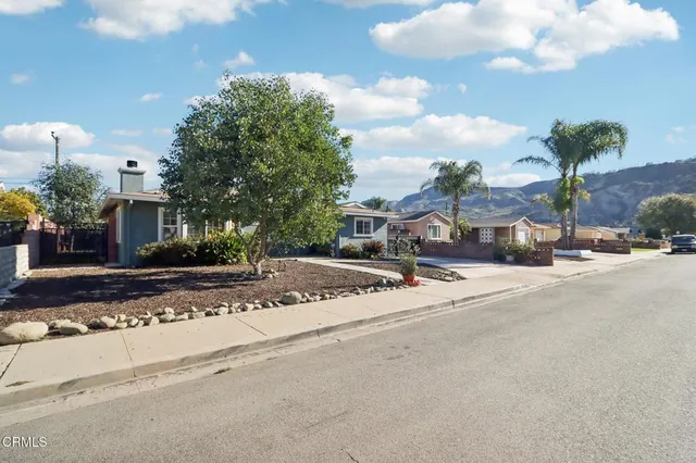 a view of a street with a cars parked