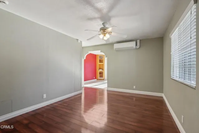 wooden floor in an empty room with a window