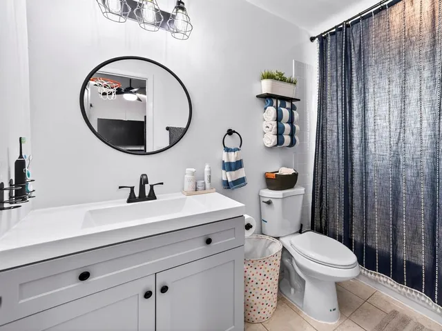 a bathroom with a toilet a sink and a mirror