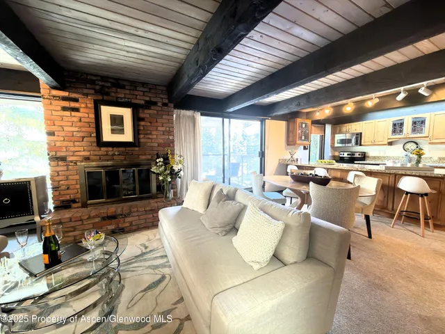 a living room with furniture wooden floor and a fireplace