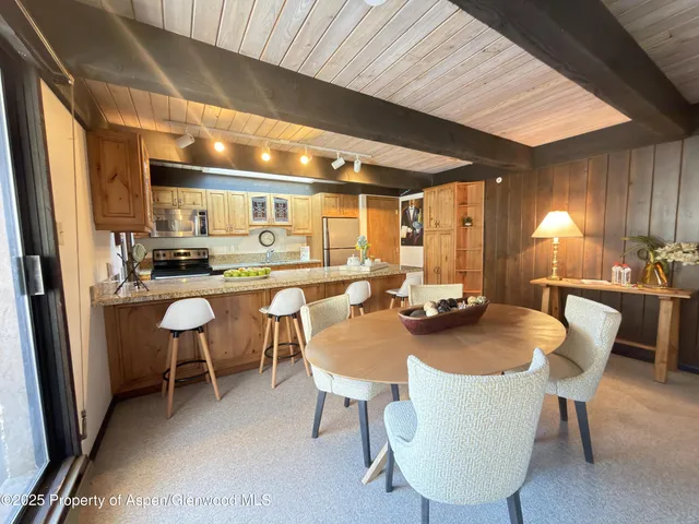 a dining room with furniture and window