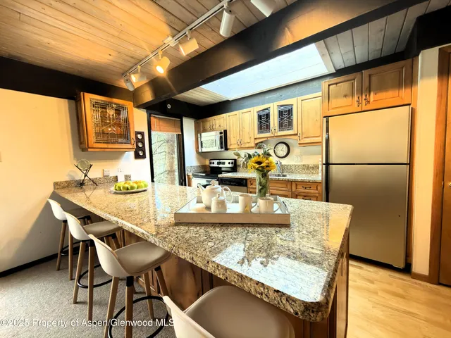 a dining table with chairs and wooden floor