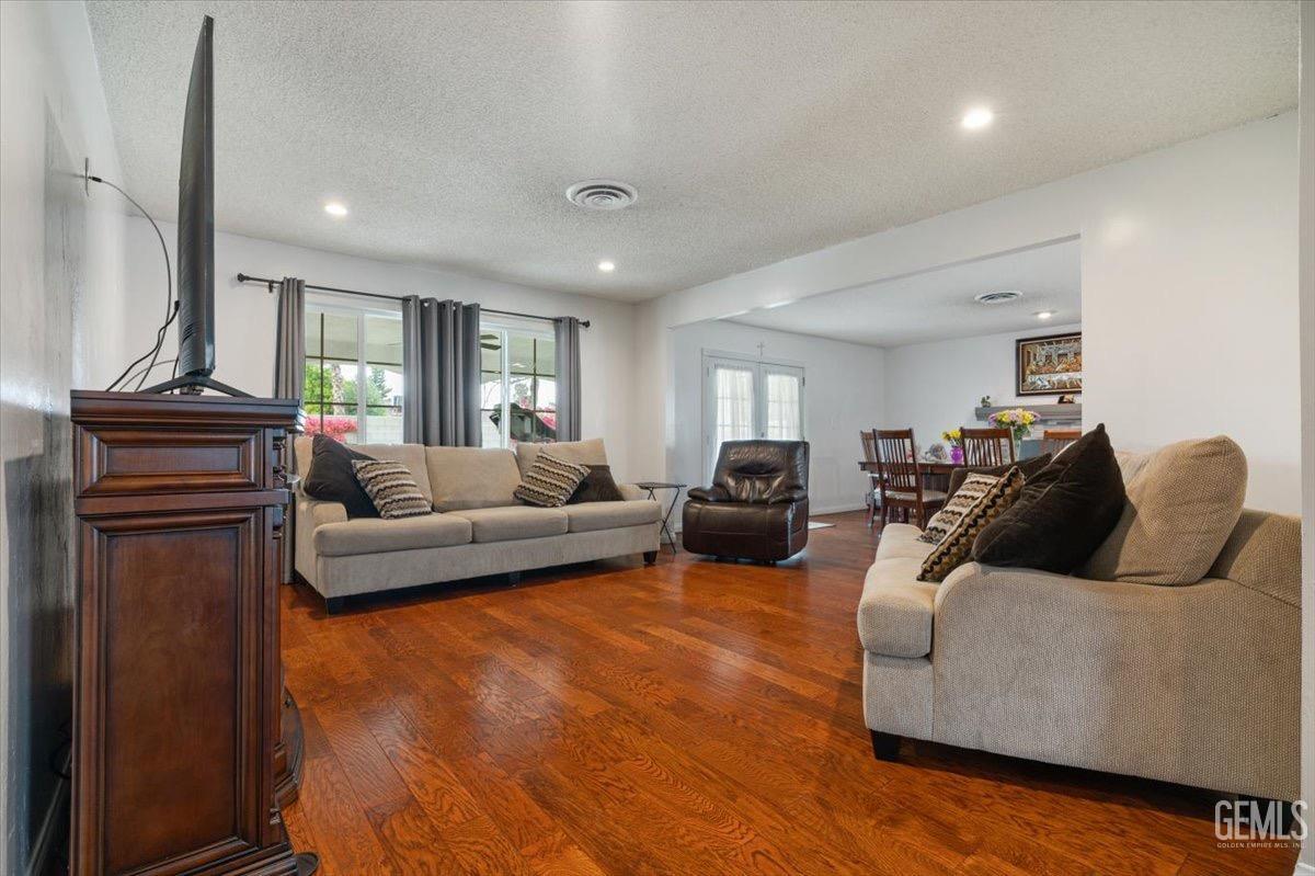 Undisclosed Address Bakersfield, CA 93309 - Photo 12 of 30 a living room with furniture and wooden floor