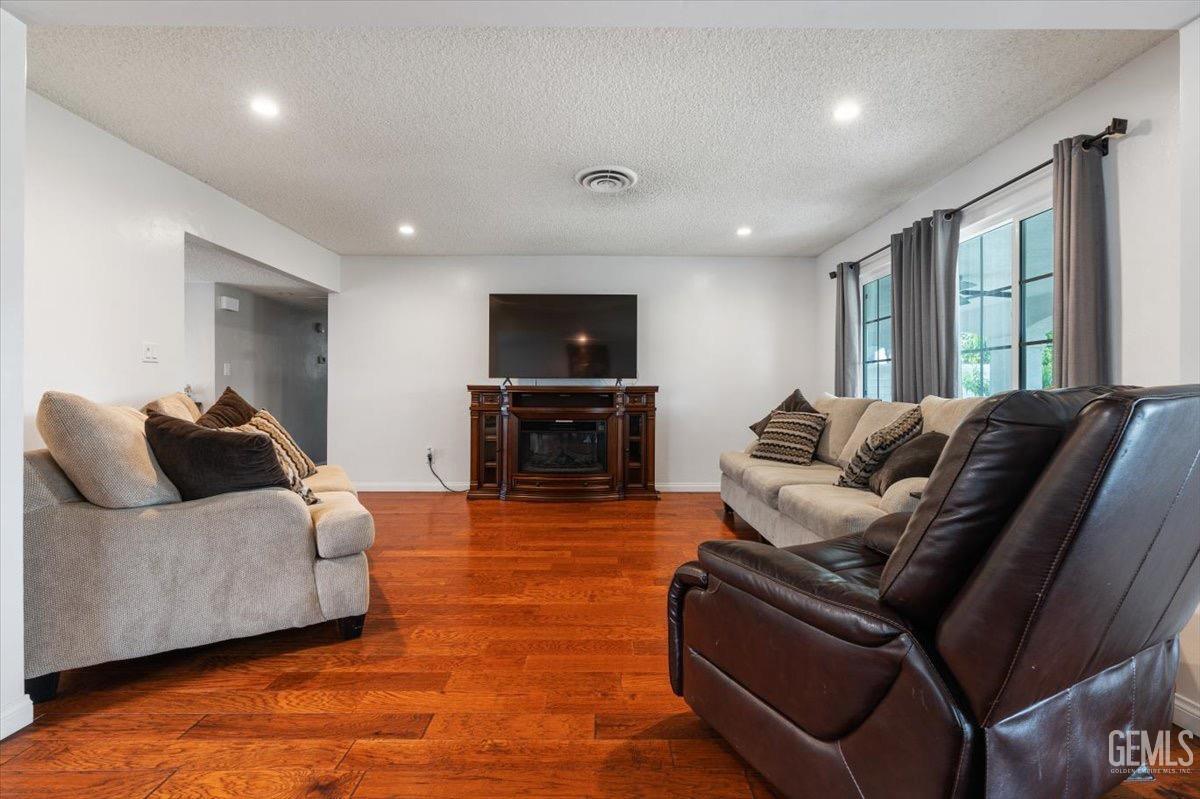 Undisclosed Address Bakersfield, CA 93309 - Photo 13 of 30 a living room with furniture and a flat screen tv