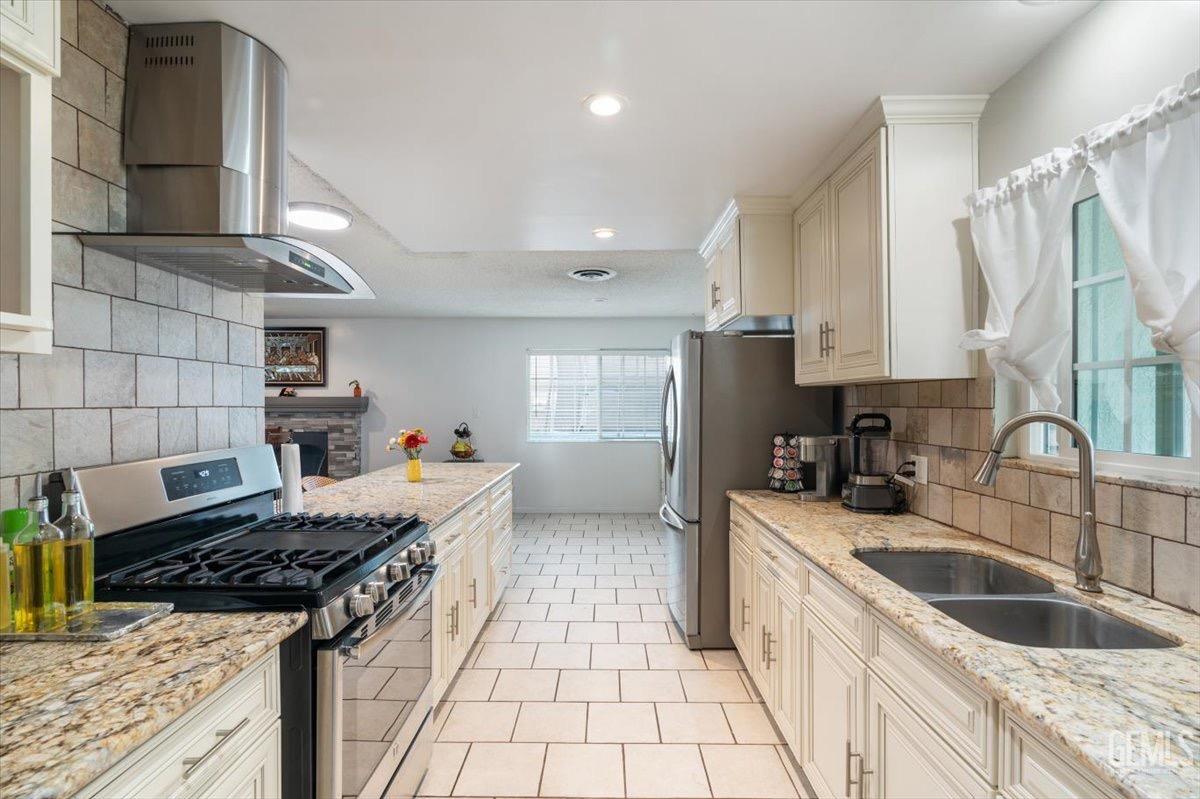 Undisclosed Address Bakersfield, CA 93309 - Photo 14 of 30 a kitchen with a sink stove top oven and cabinets