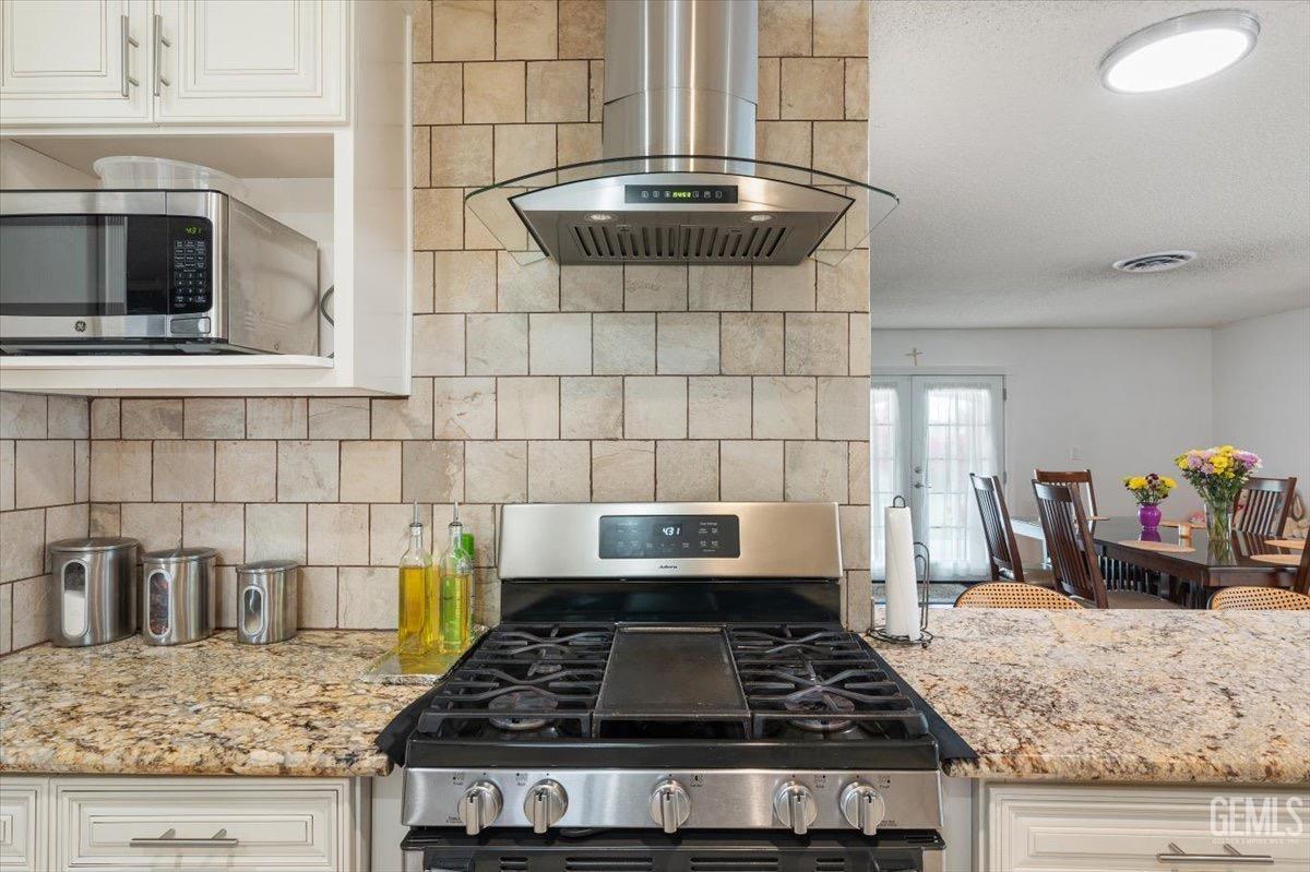 Undisclosed Address Bakersfield, CA 93309 - Photo 16 of 30 a stove top oven sitting inside of a kitchen