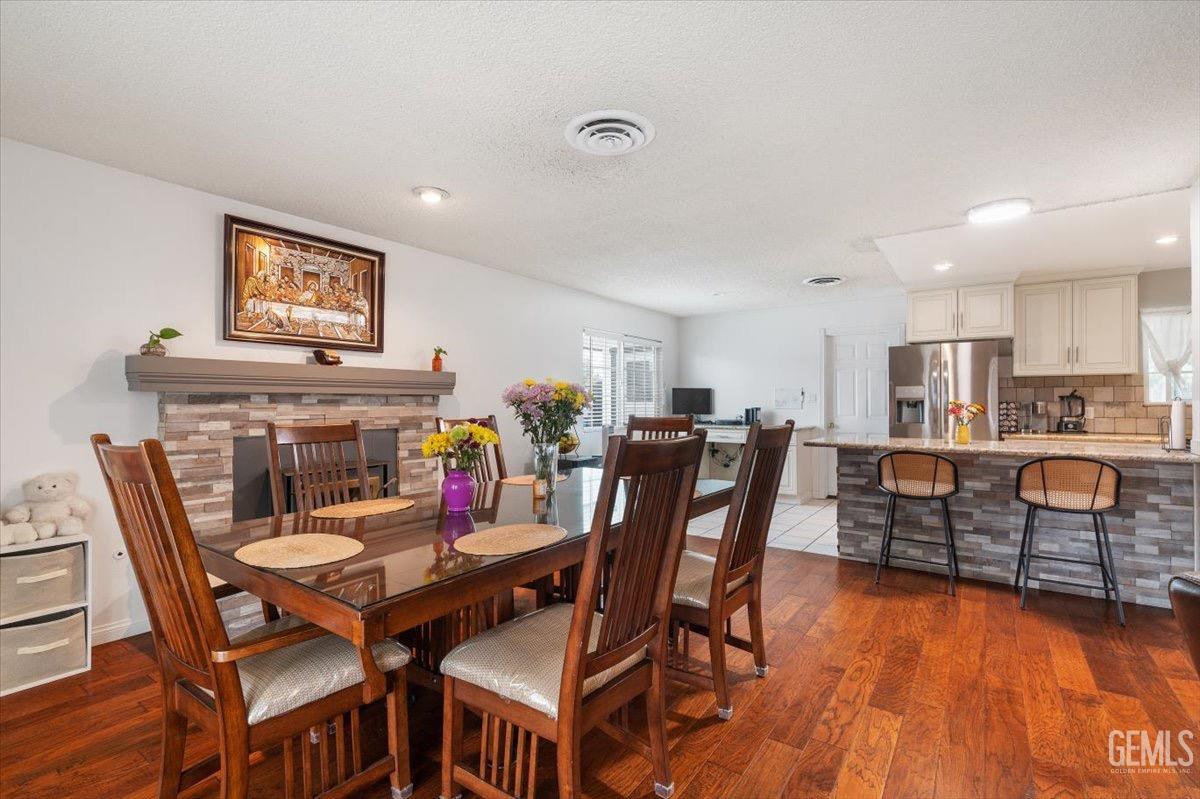 Undisclosed Address Bakersfield, CA 93309 - Photo 19 of 30 a view of a dining room with furniture and wooden floor