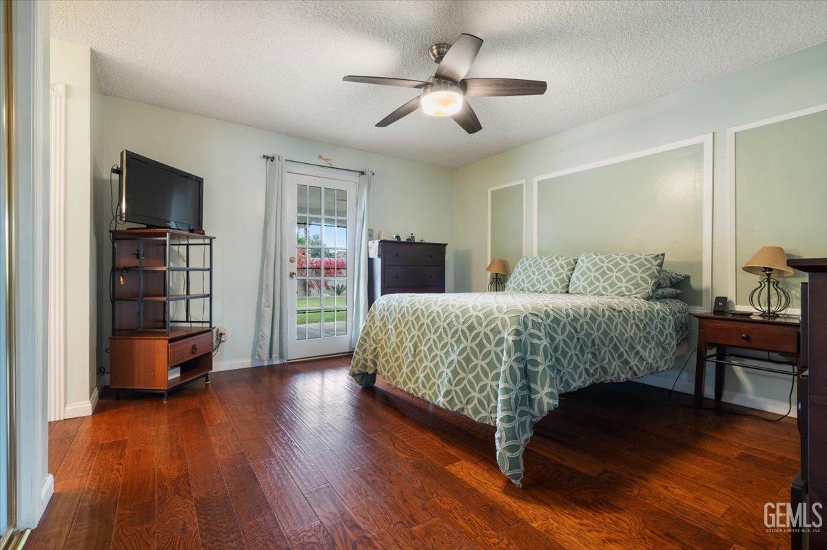 Undisclosed Address Bakersfield, CA 93309 - Photo 7 of 30 a bedroom with a bed bookshelf and a chair