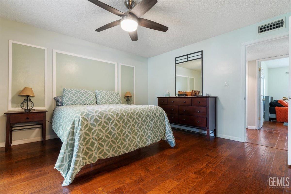 Undisclosed Address Bakersfield, CA 93309 - Photo 8 of 30 a bedroom with a bed and a dresser