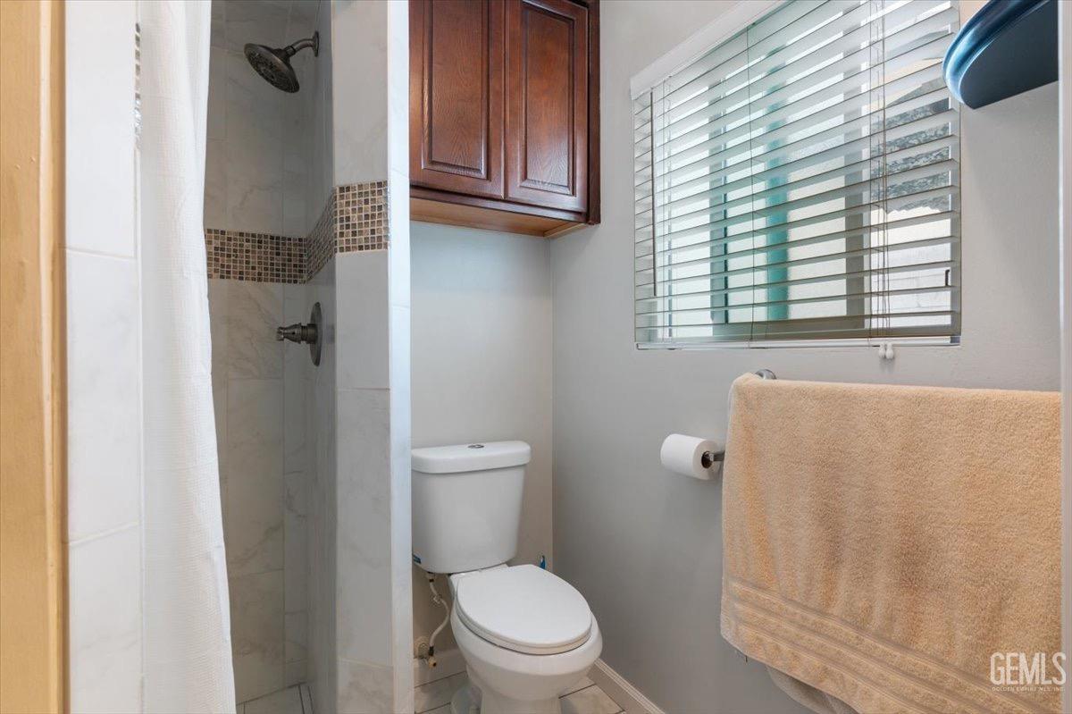 Undisclosed Address Bakersfield, CA 93309 - Photo 10 of 30 a bathroom with a toilet and a shower