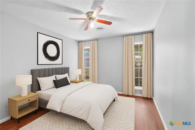 a bedroom with a large bed and a chandelier