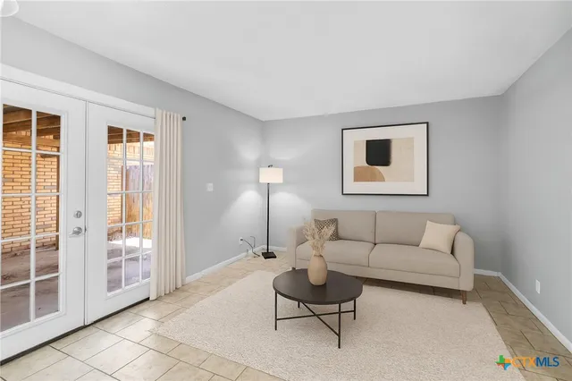 a living room with furniture and a lamp