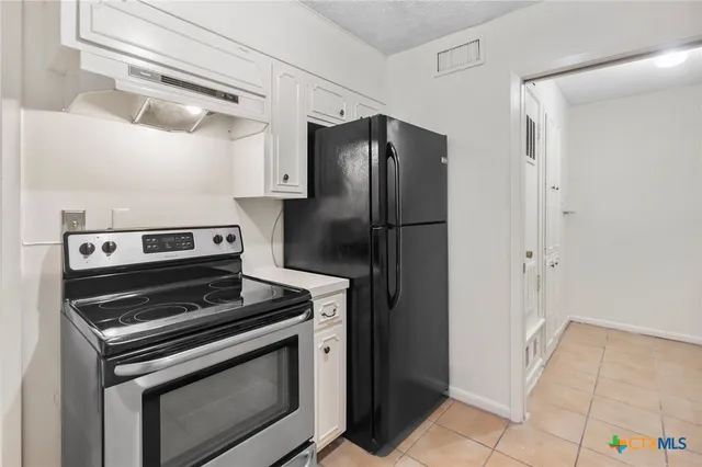 a kitchen with a stove and a refrigerator