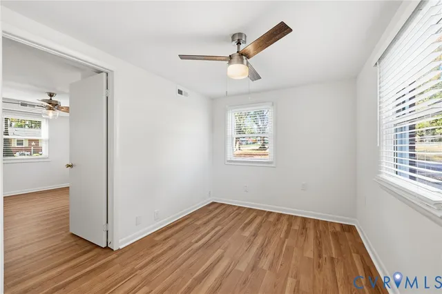 wooden floor in an empty room with a window
