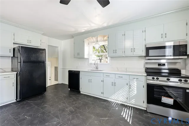 a kitchen with granite countertop white cabinets and stainless steel appliances