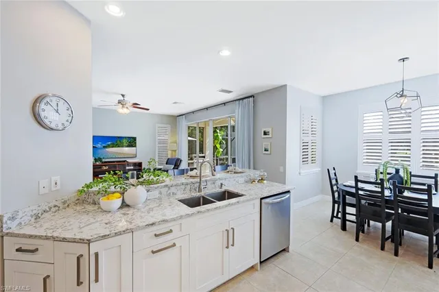 a kitchen with lots of counter space and chairs