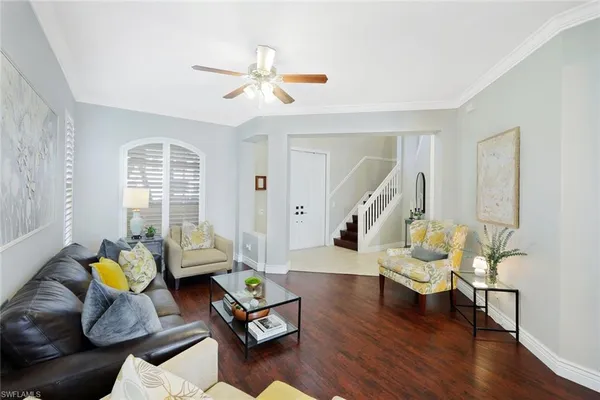 a living room with furniture and wooden floor