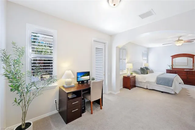 a bedroom with furniture and a potted plant