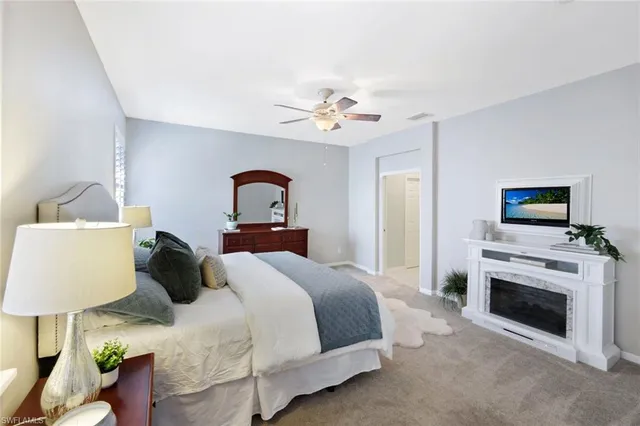 a bedroom with a bed and a fireplace