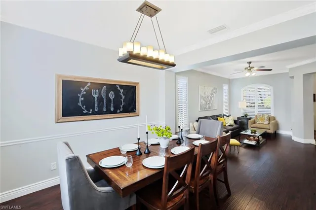 a view of a dining room with furniture wooden floor and chandelier