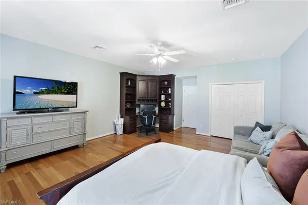 a bedroom with a bed and a flat screen tv