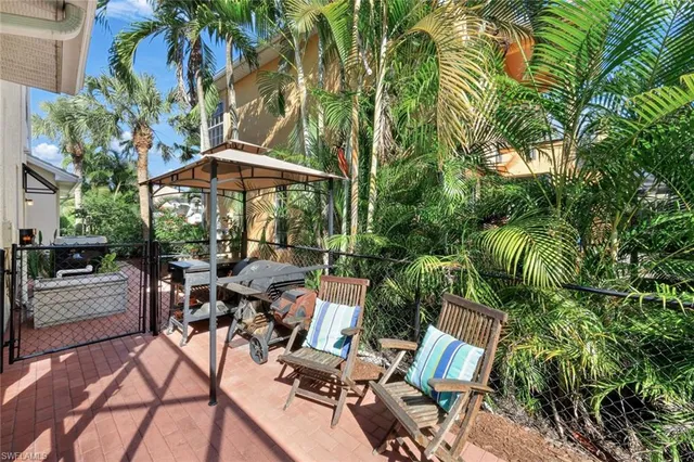 a view of a house with backyard sitting area and garden