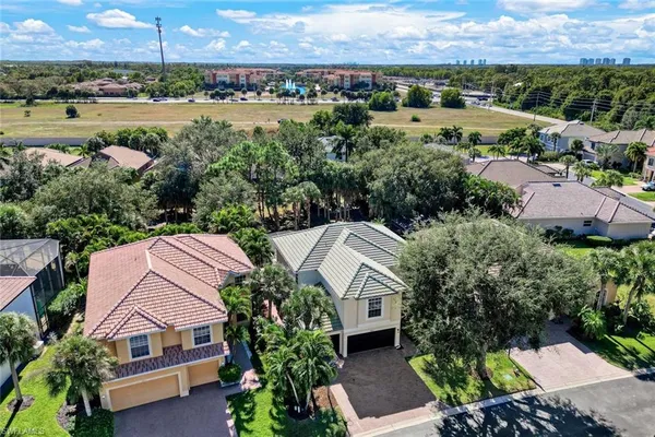 a aerial view of a house with a garden and lake view