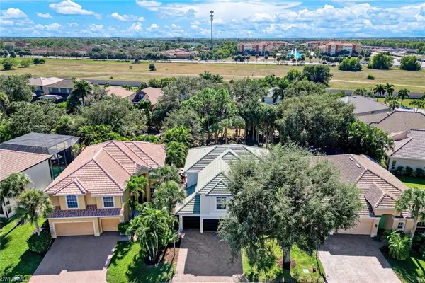 an aerial view of a city with lots of residential buildings lake and ocean view