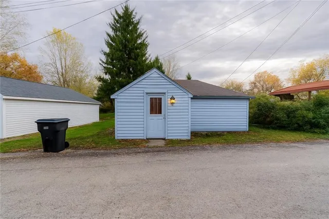 a view of a house with backyard and garage