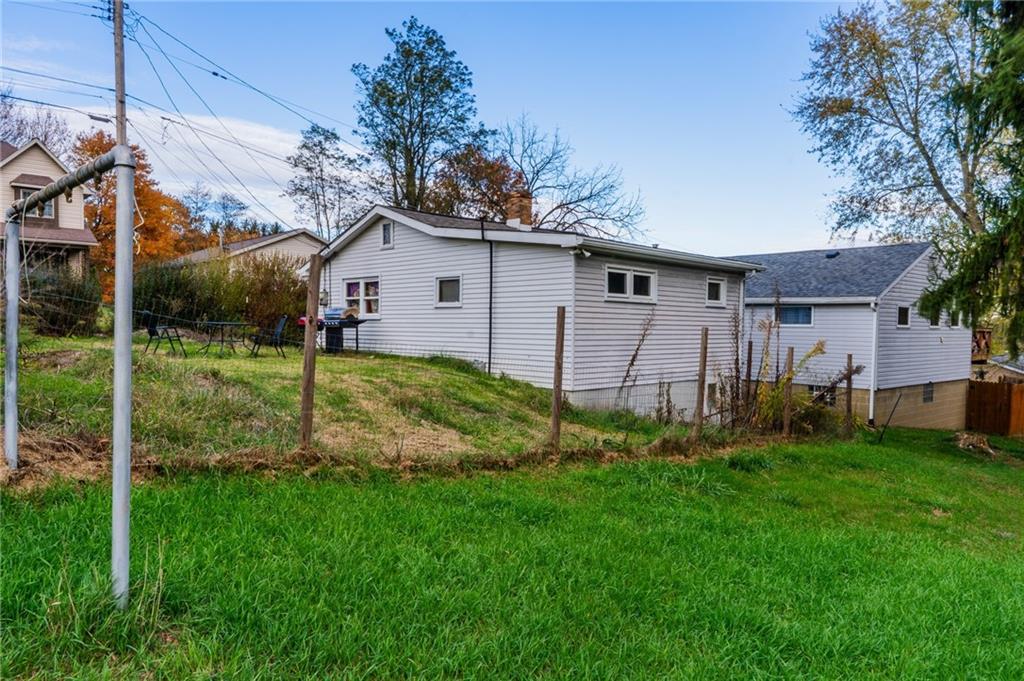 1924 Cherry Alley Monaca, PA 15061 - Photo 4 of 14 a view of a yard in front of a house with plants and large tree