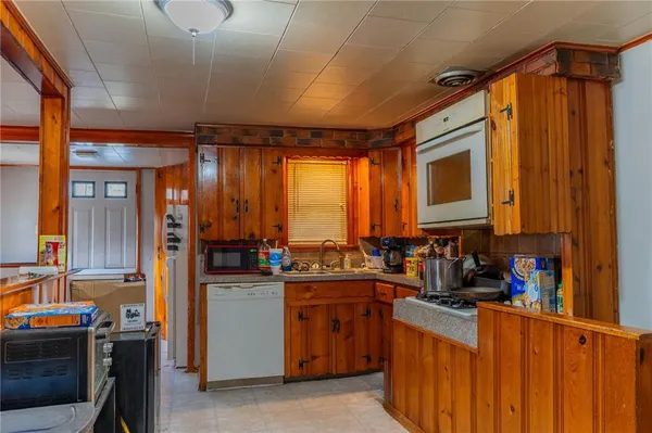 a kitchen with stainless steel appliances granite countertop a sink stove and cabinets