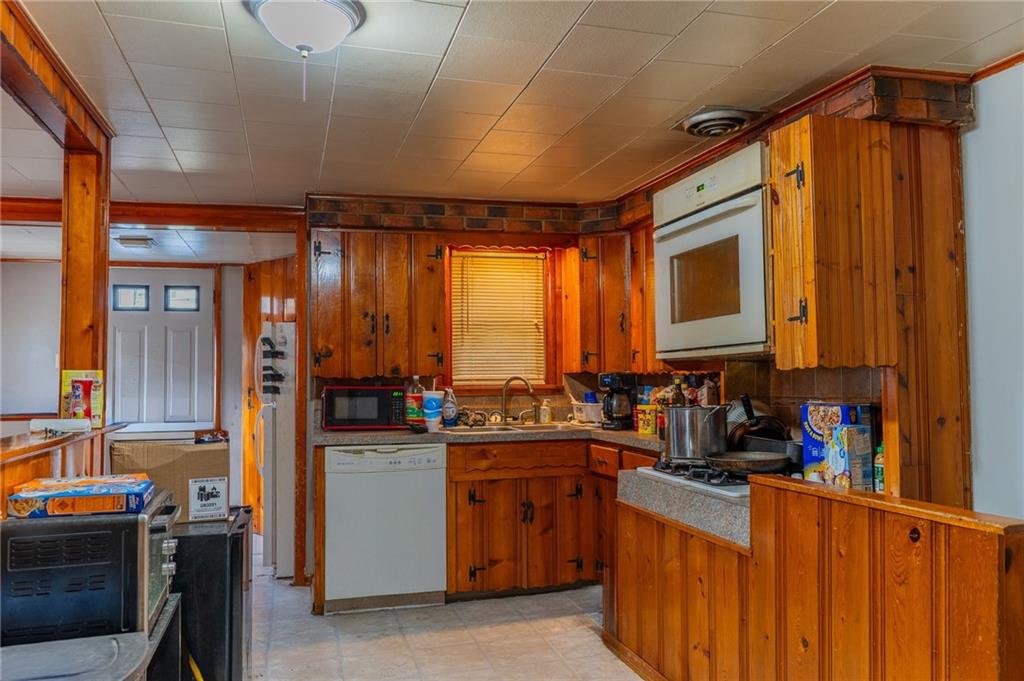 1924 Cherry Alley Monaca, PA 15061 - Photo 7 of 14 a kitchen with stainless steel appliances granite countertop a sink stove and cabinets