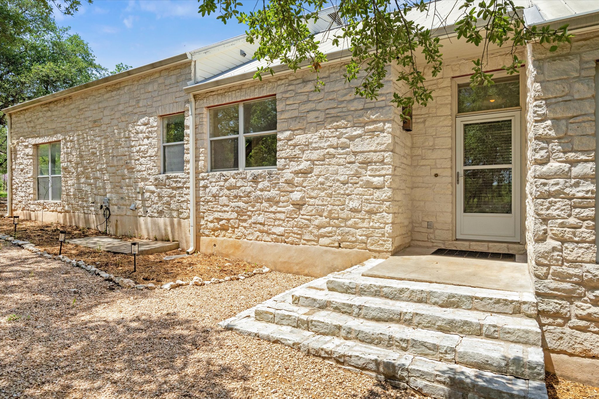 View of exterior entry with stone siding