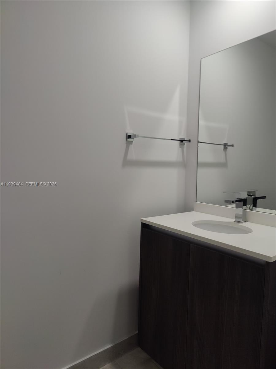 488 Northeast 18th Street, Unit 403 Miami, FL 33132 - Photo 11 of 13 a bathroom with a sink and vanity