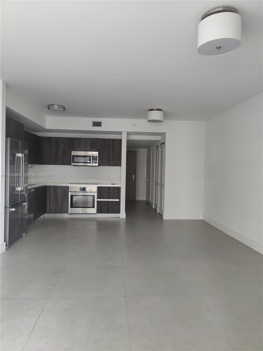 488 Northeast 18th Street, Unit 403 Miami, FL 33132 - Photo 2 of 13 a view of empty room with a fireplace