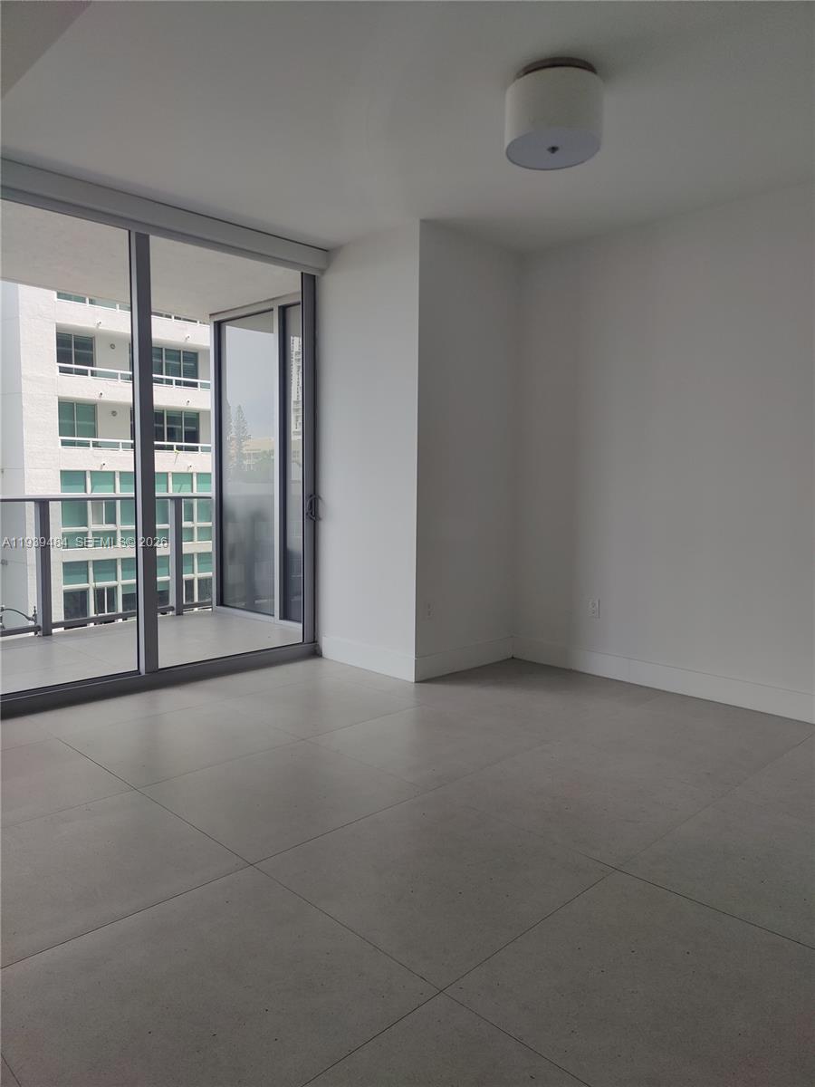 488 Northeast 18th Street, Unit 403 Miami, FL 33132 - Photo 6 of 13 an empty room with windows