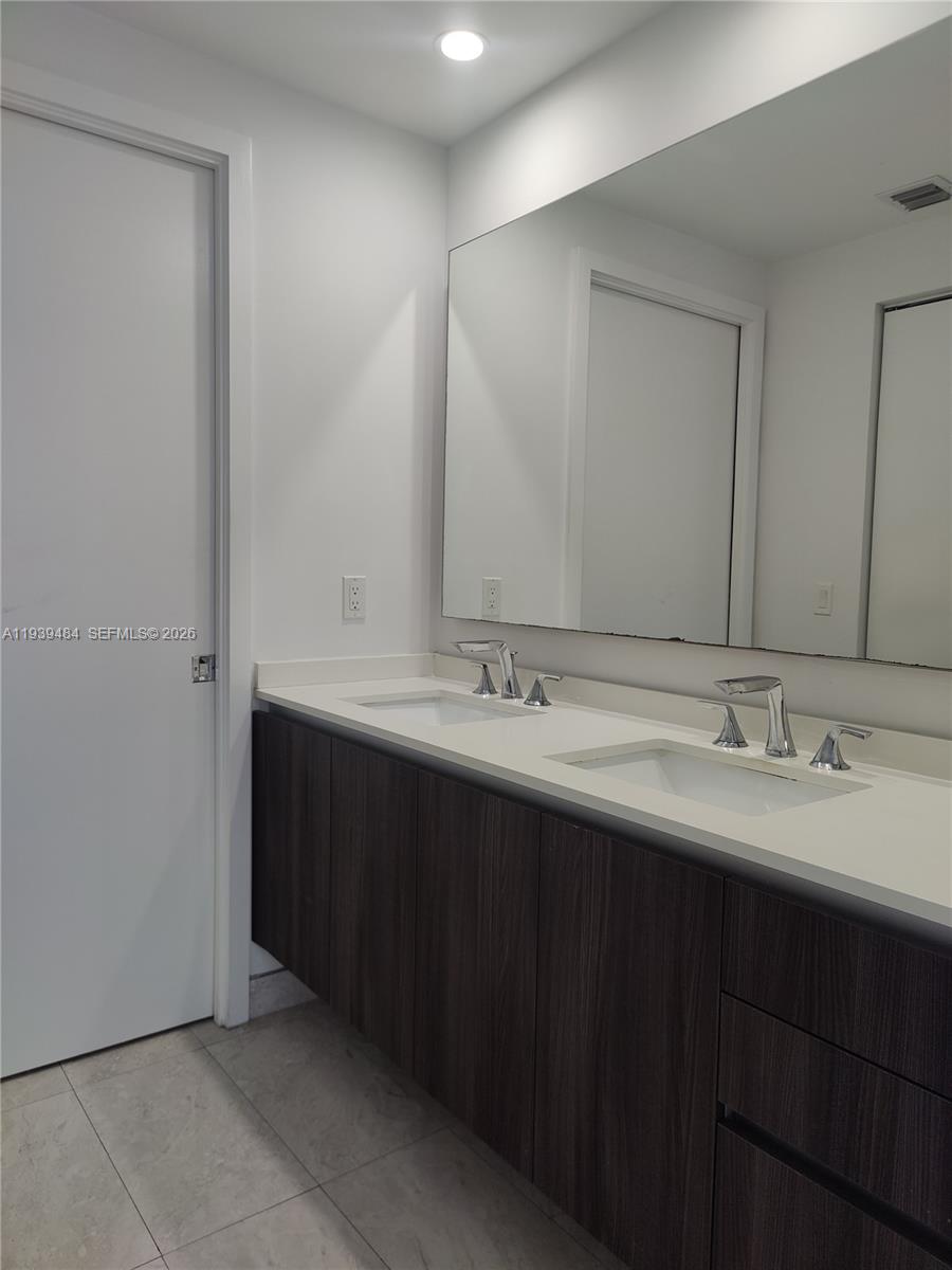 488 Northeast 18th Street, Unit 403 Miami, FL 33132 - Photo 8 of 13 a bathroom with a double vanity sink and a mirror