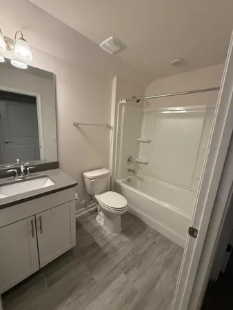 a bathroom with a toilet a sink and a bathtub
