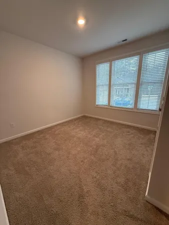 an empty room with a empty space and windows