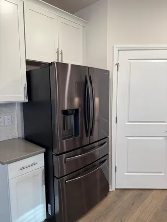 a kitchen with metallic refrigerator freezer and a dishwasher