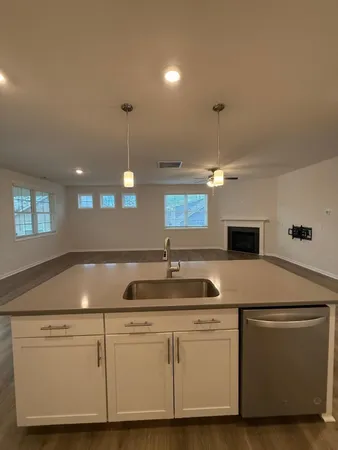 a kitchen with cabinets appliances and a chandelier