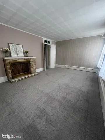 a view of a livingroom with furniture and a fireplace