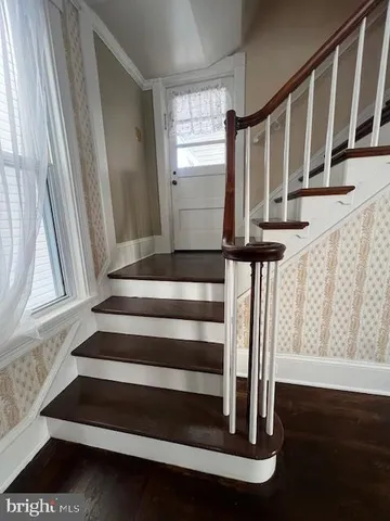 a view of an entryway with wooden floor