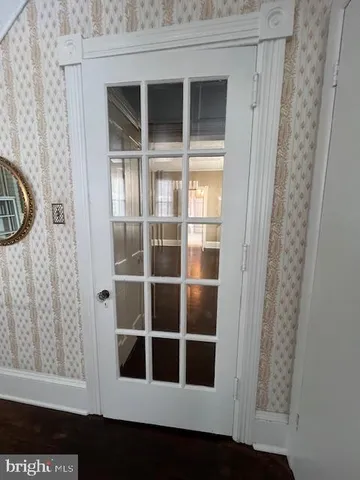a view of a room with wooden floor and windows