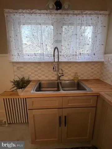 a kitchen with metallic refrigerator freezer and a dishwasher